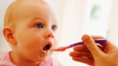 mother feeding baby food 010