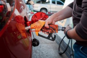 closeup man hands handle tool refueling gasoline pump into red car gas station work1