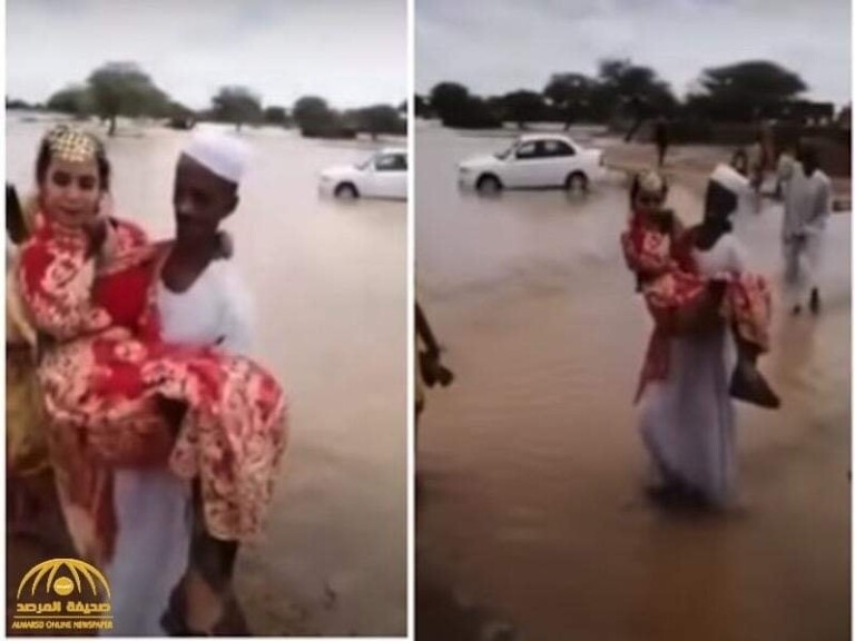شاهد بالصور.. عريس سوداني غيور يحمل عروسته بين يديه خوفاً عليها من أن تمازح ماء المطر أقدامها عريس غيور 768x576 1